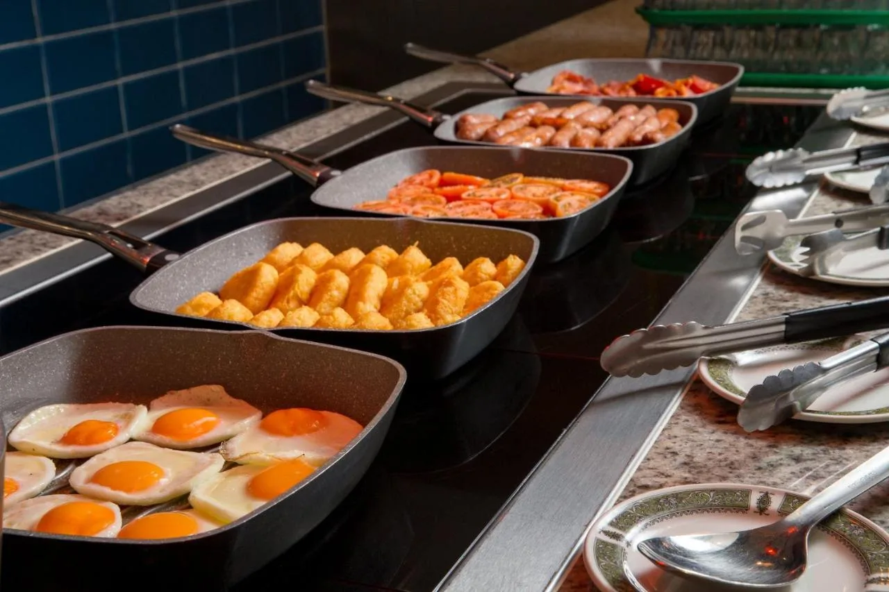 a buffet with several pans of eggs and other food at Tavistock Hotel in London