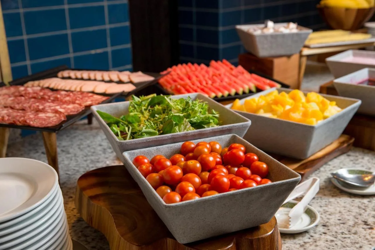 a table with bowls of tomatoes and other fruits and vegetables at Tavistock Hotel in London